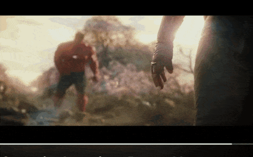 a man in a superhero costume reaches out towards another man