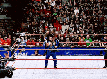 a wrestling ring with a sign that says the greatest wrestlers in the world on it
