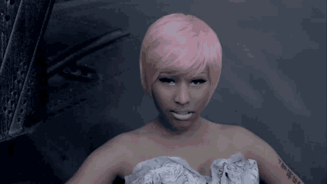 a woman with pink hair has a tattoo on her arm that says tms