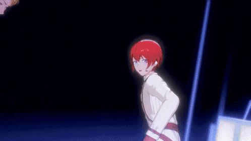 a man with red hair and a white jacket is dancing