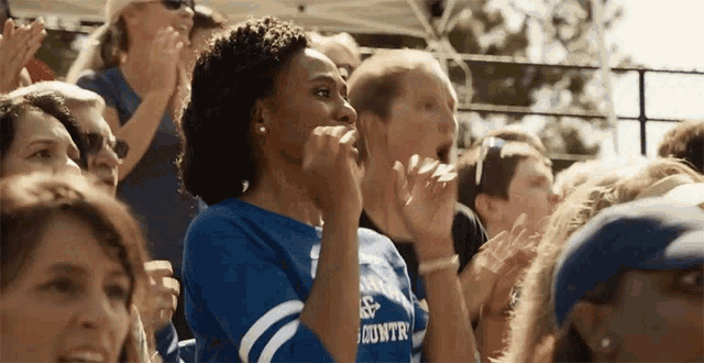 a woman wearing a blue shirt that says country