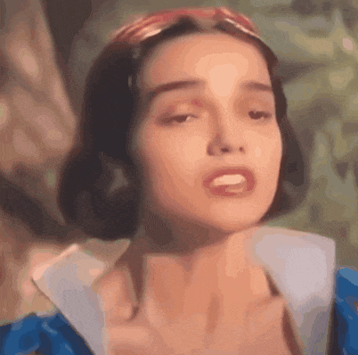a close up of a woman 's face wearing a blue dress and a red headband .