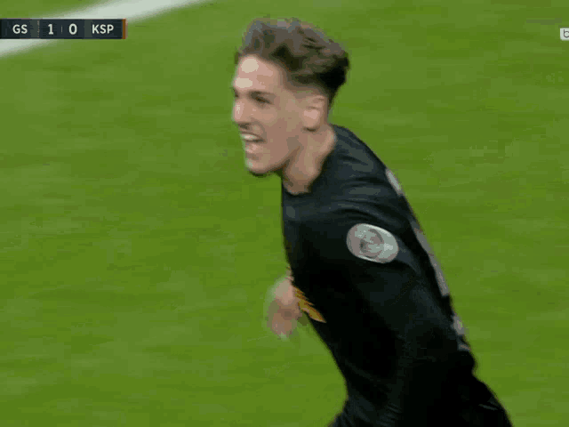 a soccer player wearing a black jersey that says ' gs ' on it