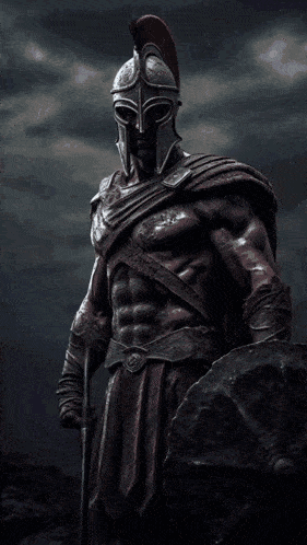 a statue of a warrior with a welcome sign below him