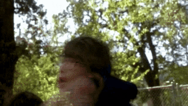 a blurry picture of a person standing in front of a tree