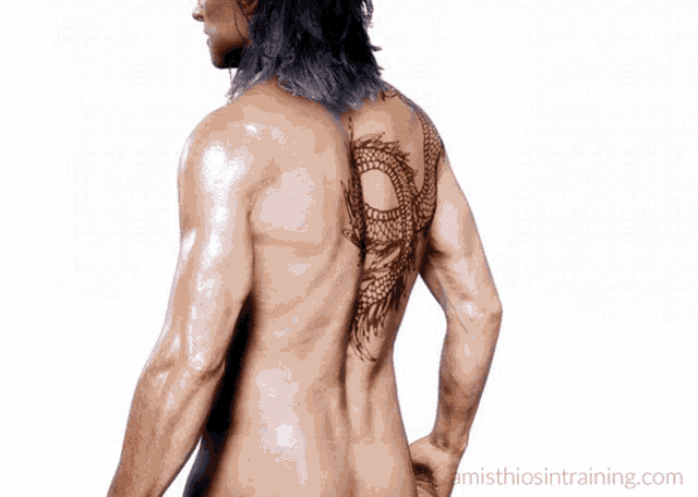 a naked man with a dragon tattoo on his back is standing in front of a white background