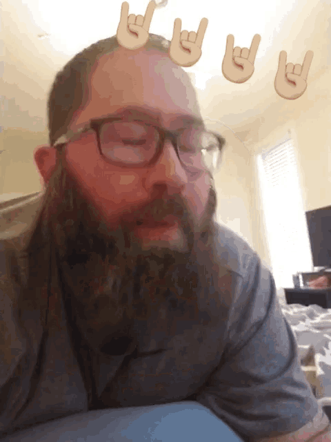 a man with glasses and a beard has a sign on his head that says rock on