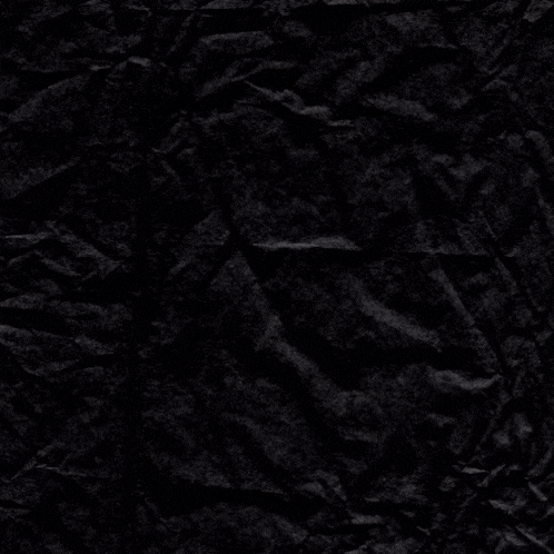 a crumpled piece of black paper with a purple circle in the middle