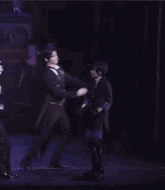 a group of people are dancing on a stage in a theater .