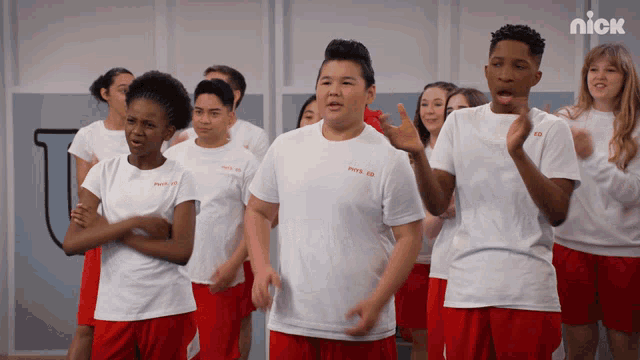 a group of kids wearing red shorts and white shirts with the nick logo on the bottom