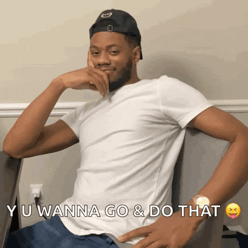 a man wearing a white shirt and a black hat says yu wanna go and do that