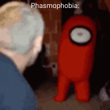 a red among us character is standing next to a man .