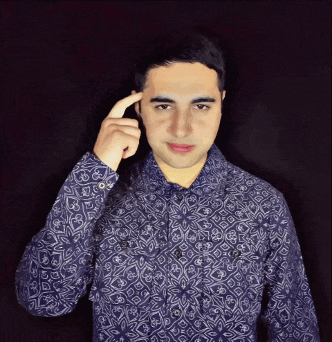 a man wearing a blue shirt with a floral pattern holds his hand to his forehead