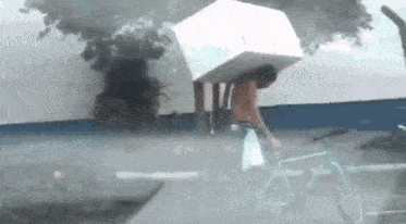 a man with a box on his head is riding a bicycle