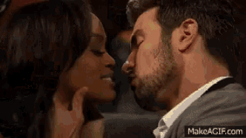 a man and a woman are kissing each other in a movie theater .