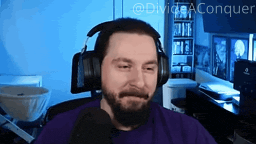a man with a beard wearing headphones and a purple shirt with the words divide aconquer on the bottom