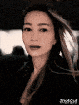 a woman 's face is shown in a shot out video