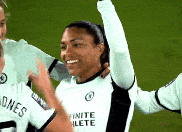 a woman wearing a white shirt that says finite athlete