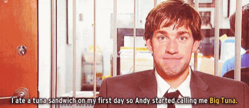 a man in a suit and tie is talking about a tuna sandwich