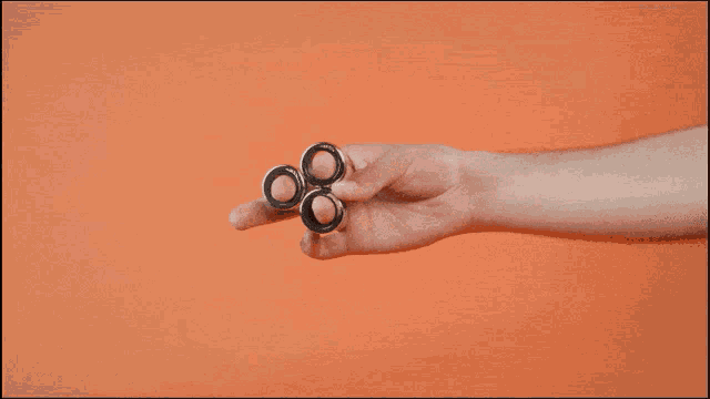 a person holding a pair of rings on their finger