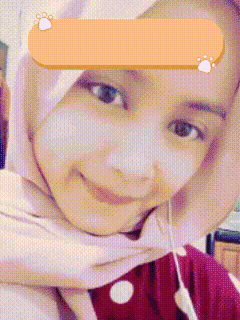 a close up of a woman wearing a hijab and a red shirt