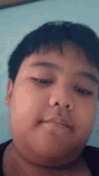 a close up of a child 's face with a slight smile on his face