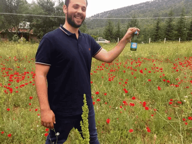 a man in a blue shirt is holding a bottle of sprite