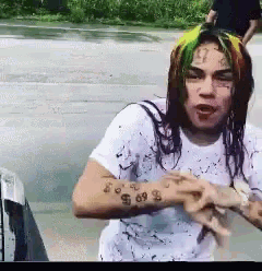 a man with a tattoo on his arm that says ' 69 '
