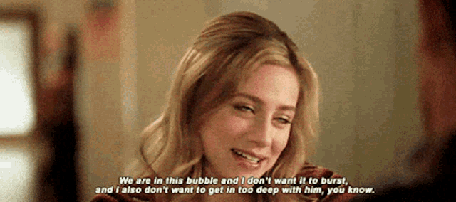 a woman is smiling and saying " we are in this bubble "