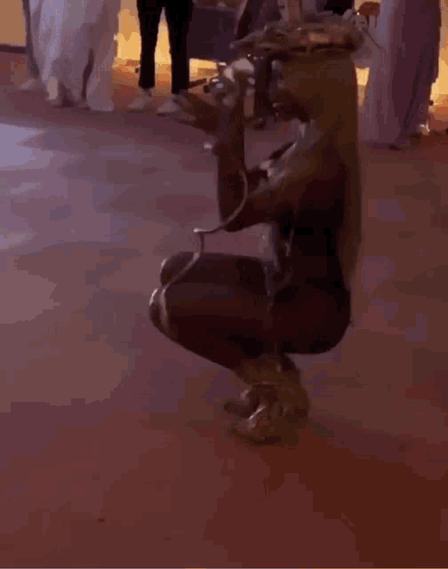 a woman in a cowboy outfit is squatting down on the floor