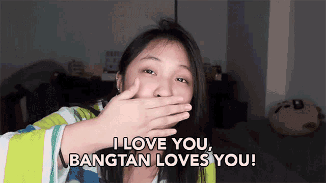 a girl covering her mouth with her hand and the words i love you bangtan loves you