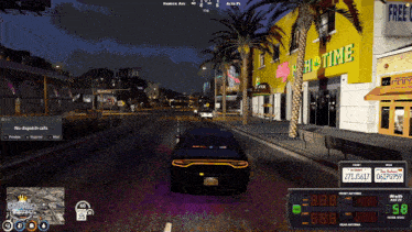 a car is driving down a street in front of a building that says " big time "