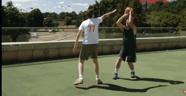 a man wearing a white shirt with 77 on it