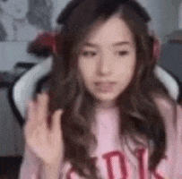 a woman wearing headphones and a pink shirt is giving a middle finger .