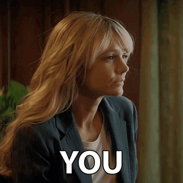 a woman in a suit is saying you
