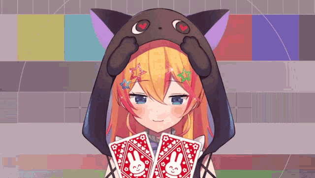 a girl in a cat hat is holding two playing cards with bunny faces on them