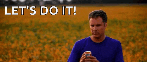 a man in a blue shirt is holding a can of soda in a field of sunflowers .