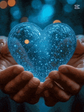 a person is holding a blue heart in their hands with the letter x in the corner