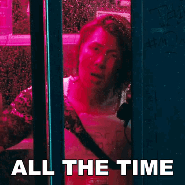 a woman looking out a window with the words " all the time " below her