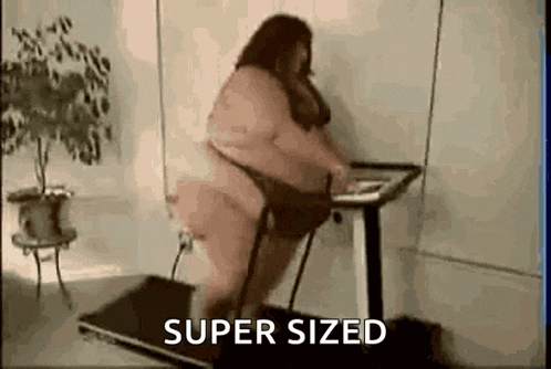 a very fat woman is walking on a treadmill in a room .