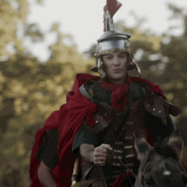 a man in armor is riding a horse and holding a sword