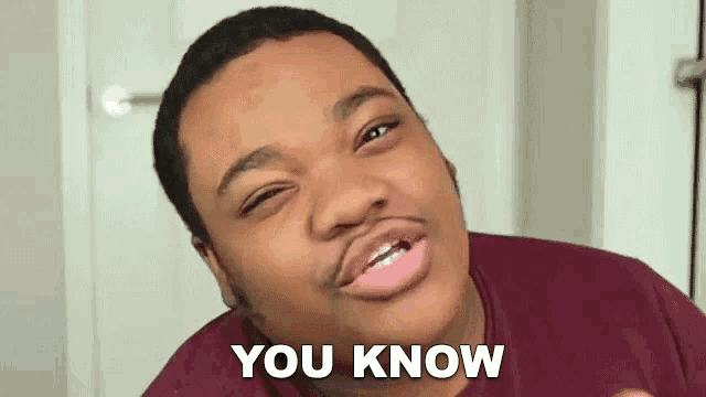 a young man in a maroon shirt is making a funny face and says `` you know '' .