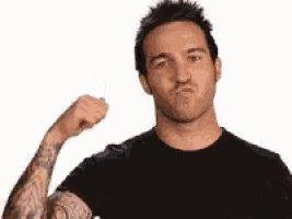a man with tattoos on his arms is flexing his muscles .
