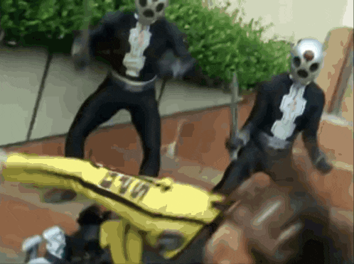 a man in a black suit is standing next to a man in a yellow jacket with the word evo on it
