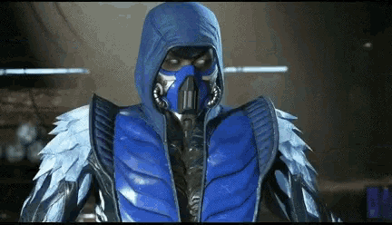 a man in a blue suit with a hood and a mask on his face .