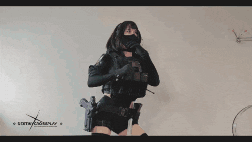 a woman is holding a gun in front of a destiny crossplay banner