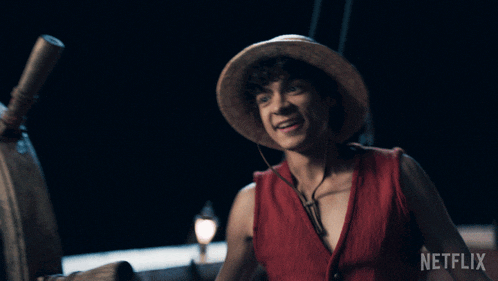 a man in a straw hat is standing in front of a steering wheel with netflix written on the bottom