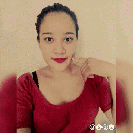 a woman in a red shirt is taking a selfie with the numbers b612 on the bottom