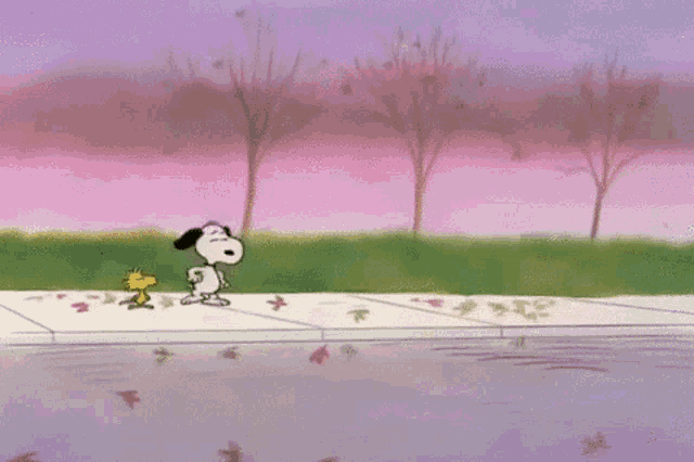 snoopy and woodstock are walking down a sidewalk near a body of water .