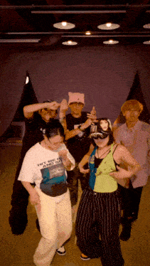 a group of people are dancing and one of them is wearing a shirt that says hit me